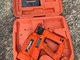 a close up of an orange tool box with a stapler in it