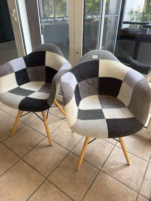 two chairs that are sitting on a tiled floor