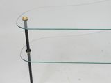 a glass and brass coffee table with two shelves