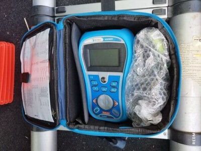 a blue and black electronic device inside of a bag