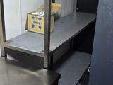 a metal shelf with boxes on it in a kitchen