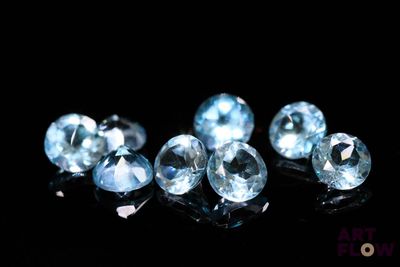 some very pretty blue diamonds on a black surface