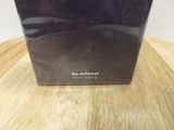 the box of the perfume is sitting on the table on the table