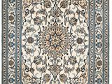un tapis blanc et bleu orné d'un motif floral