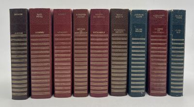 six books are lined up in a row on a white surface