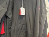 two men ' s jackets hanging on a rack in a store
