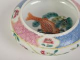 a small bowl with a fish in it sitting on a table