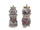 two vases with flowers on them sitting next to each other