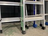 two ladders are sitting next to each other on a concrete floor
