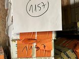 une pile de sacs orange sur lesquels sont inscrits des mots