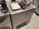 stainless steel counter top in a commercial kitchen with a blender and a coffee maker