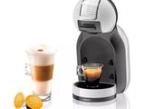 an image of a coffee machine with a cup of coffee next to it