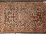 a large antique persian rug with a floral design
