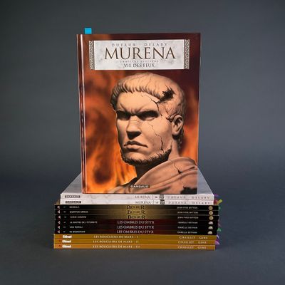 books stacked on top of each other on a gray surface