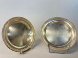 pair of silverplated plates with beaded rims on stands