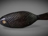a small wooden fish that is sitting on a table