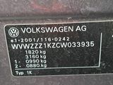 the back end of a car with a volkswagen logo on it ' s side