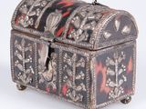 an antique silver and tortoise decorated box on wheels