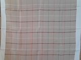 the white and red plaid scarf is hanging on the wall