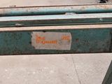 a sign on the back of a bench that says don ' t judge