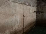 concrete wall with a grate grate in the middle of it and a grate in the middle of it