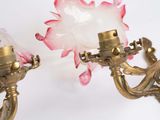 two wall lights that are attached to a wall