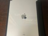 an apple ipad sitting on a table next to a wall