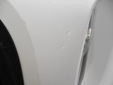 a close up of a car ' s front bumper with scratches on it