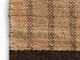 a close up of a woven rug on a white surface