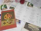 a table with a bunch of postcards and pictures on it