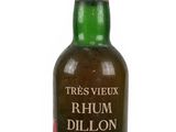 a close up of a bottle of rum on a white surface