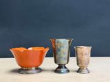 three vases sitting on a table next to each other