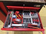 a red tool box with tools in it on the floor