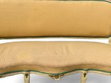 an image of a gold colored couch with a green trim