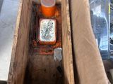 a wooden box with a bottle in it sitting on a table