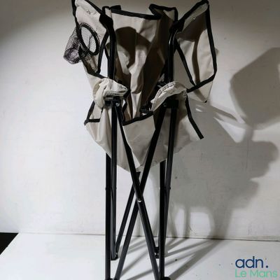 a black and white photo of a chair and a bag