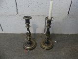 two candles that are sitting on the ground