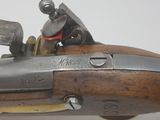 an old gun with a wooden barrel and a metal handle