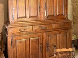 a large wooden cabinet in the middle of a room