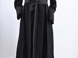 an image of a mannequin dressed in a black coat and skirt