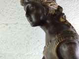 a statue of a woman holding a basket of flowers