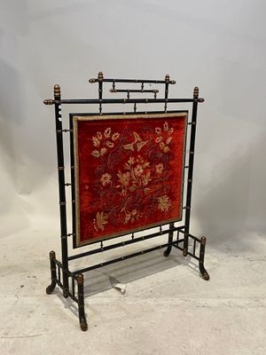 une image représentant une tapisserie rouge et dorée posée sur un support noir