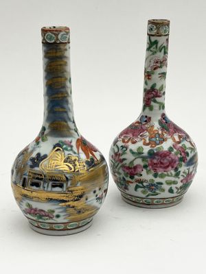 pair of chinese vases with floral designs on them on a white surface