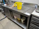 a yellow bucket sitting on top of a stainless steel counter