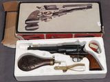 une boîte contenant un pistolet, posée sur une table