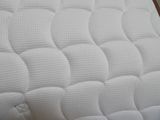 a close up of a mattress on a bed frame