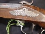 a close up of a gun that has a bat on it
