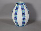 a blue and white vase sitting on a table