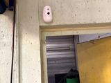 a picture of a room with a door and a light on