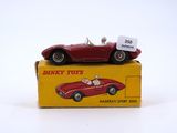 a red toy car sitting on top of a yellow box
